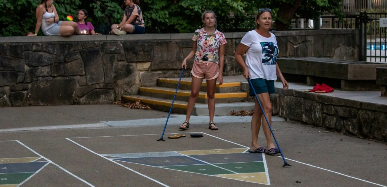 Family playing shuffleboard