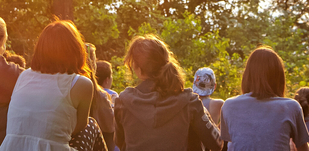 Group Of Teens On Hill At Sunset